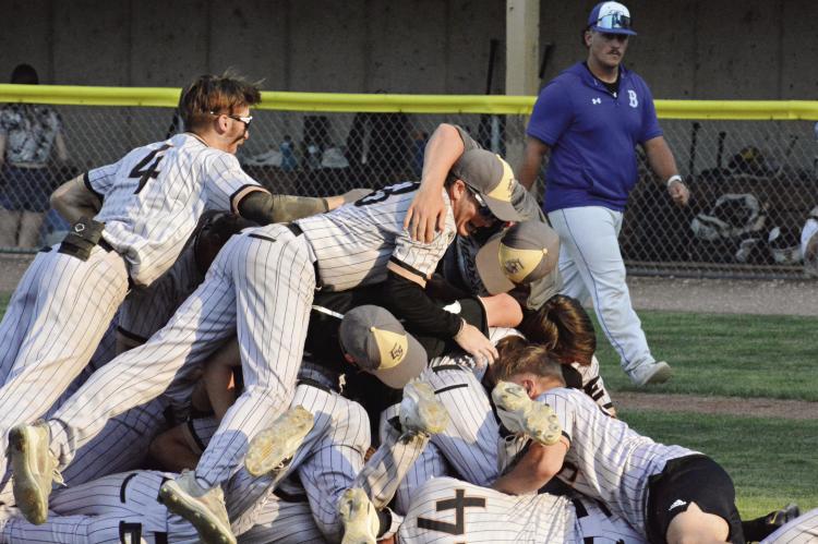 MEMBERS OF THE Excelsior Springs varsity baseball team dogpile on one another May 25 after the Tigers win their Class 4 state quarterfinal meeting with Boonville at Harley Park-Oscar Twillman Field. SHAWN RONEY | Staff