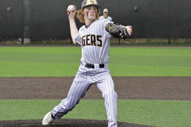 COOPER COLLINS helps Excelsior Springs get Aaron Holst his 300th coaching victory by pitching in relief against Raytown April 28 at Tiger Stadium.