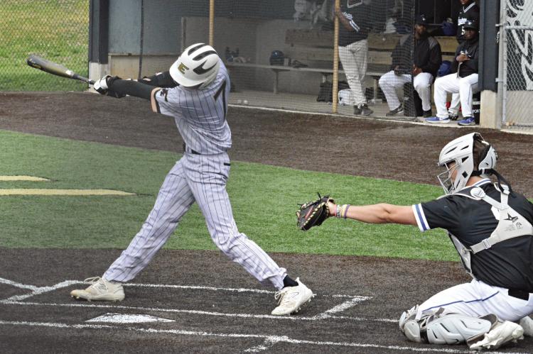 WITH HIS head down and his arms extended, Kaelan Bedford takes a mighty swing during Excelsior Springs’ 13-5 victory over Raytown April 28 at Tiger Stadium. SHAWN RONEY | Staff