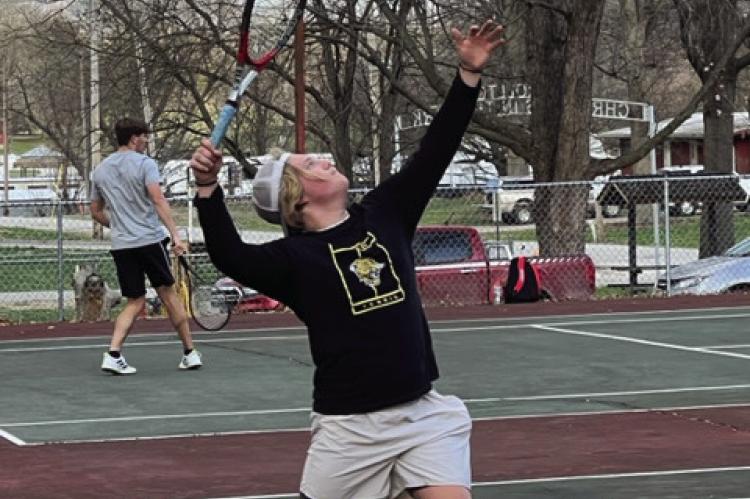 EXCELSIOR SPRINGS senior Lee Mueller serves an during the Tigers’ 5-4 dual victory of Lafayette County March 27 at Higginsville. DUSTIN DANNER | Staff