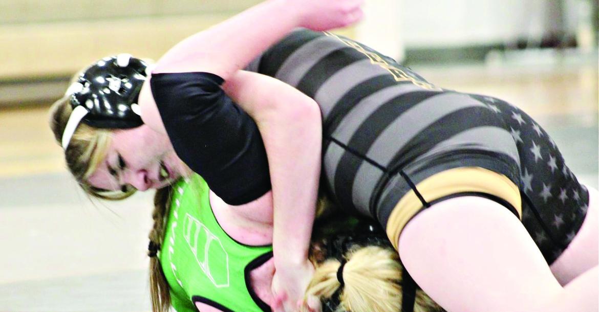 EXCELSIOR SPRINGS sophomore Lauren Park, top, secures a half nelson and puts Smithville’s Jenna Holmes to the mat to help the Tigers edge the Warriors in a 39-36 Jan. 4 dual at Excelsior Springs High School. DUSTIN DANNER | Staff