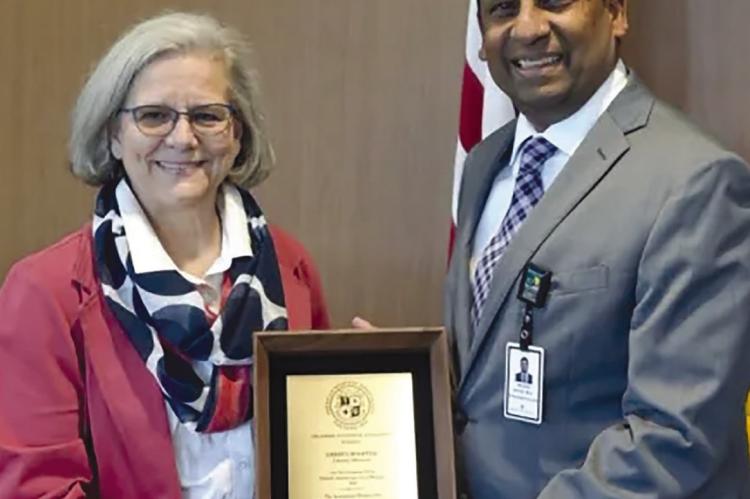 AMERICAN HOSPITAL ASSOCIATION Regional Executive Liz Sumy (left) presents Liberty Hospital President and CEO Raghu Adiga with an award of recognition for the hospital’s participation and leadership within the organization. Submitted